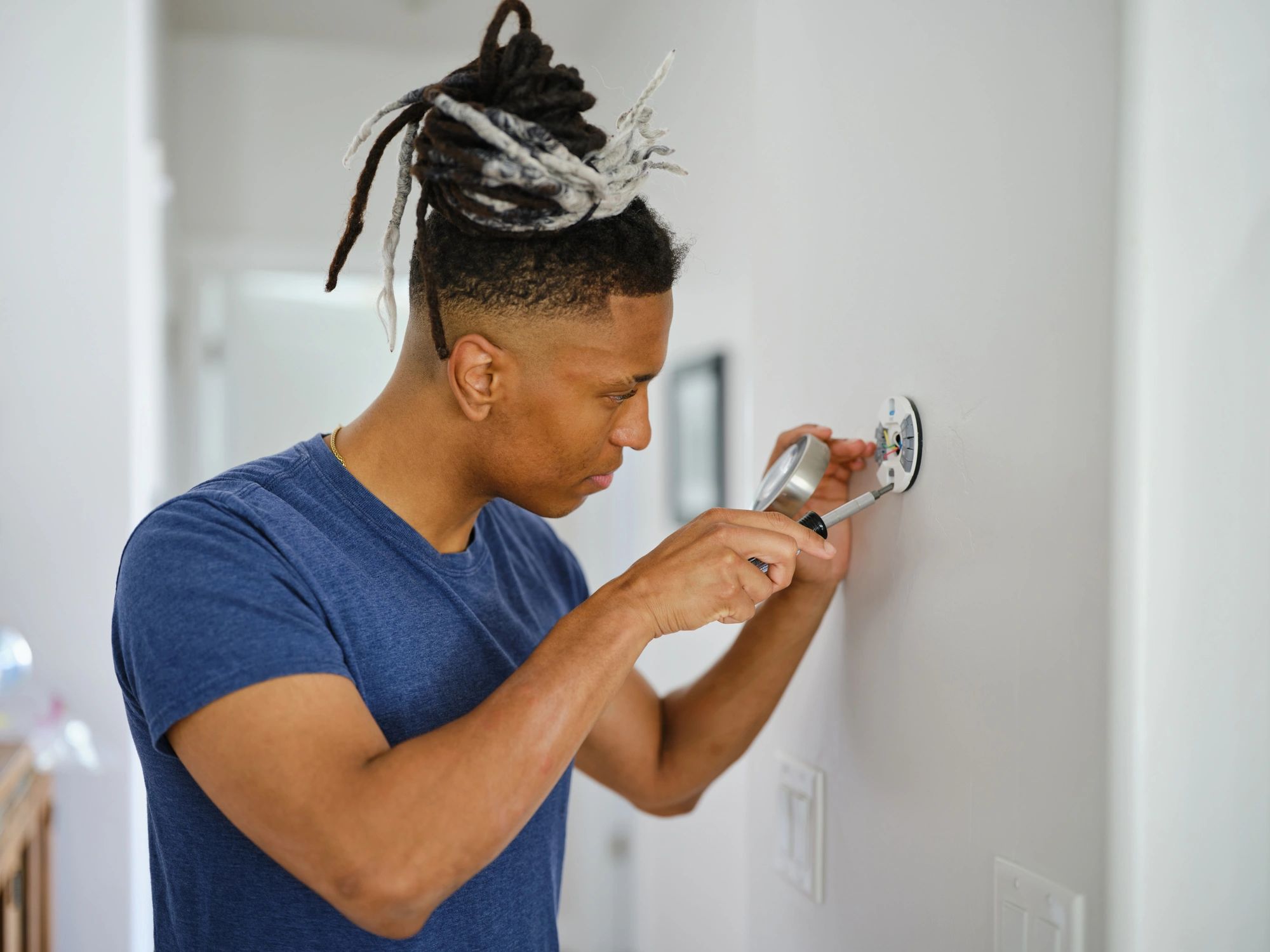 Technician installing a security system in a residential setting